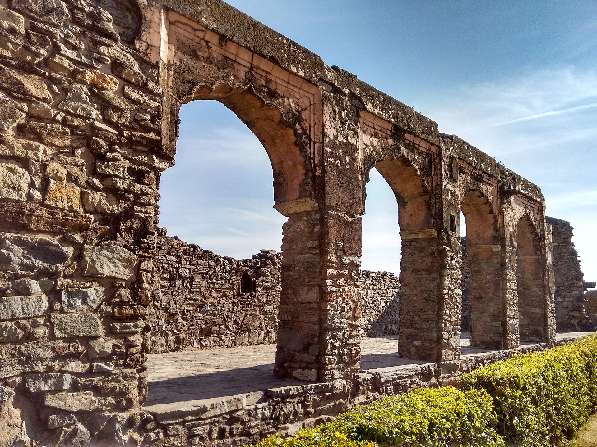 Ruined stone arches typical of Mewar fort complexes