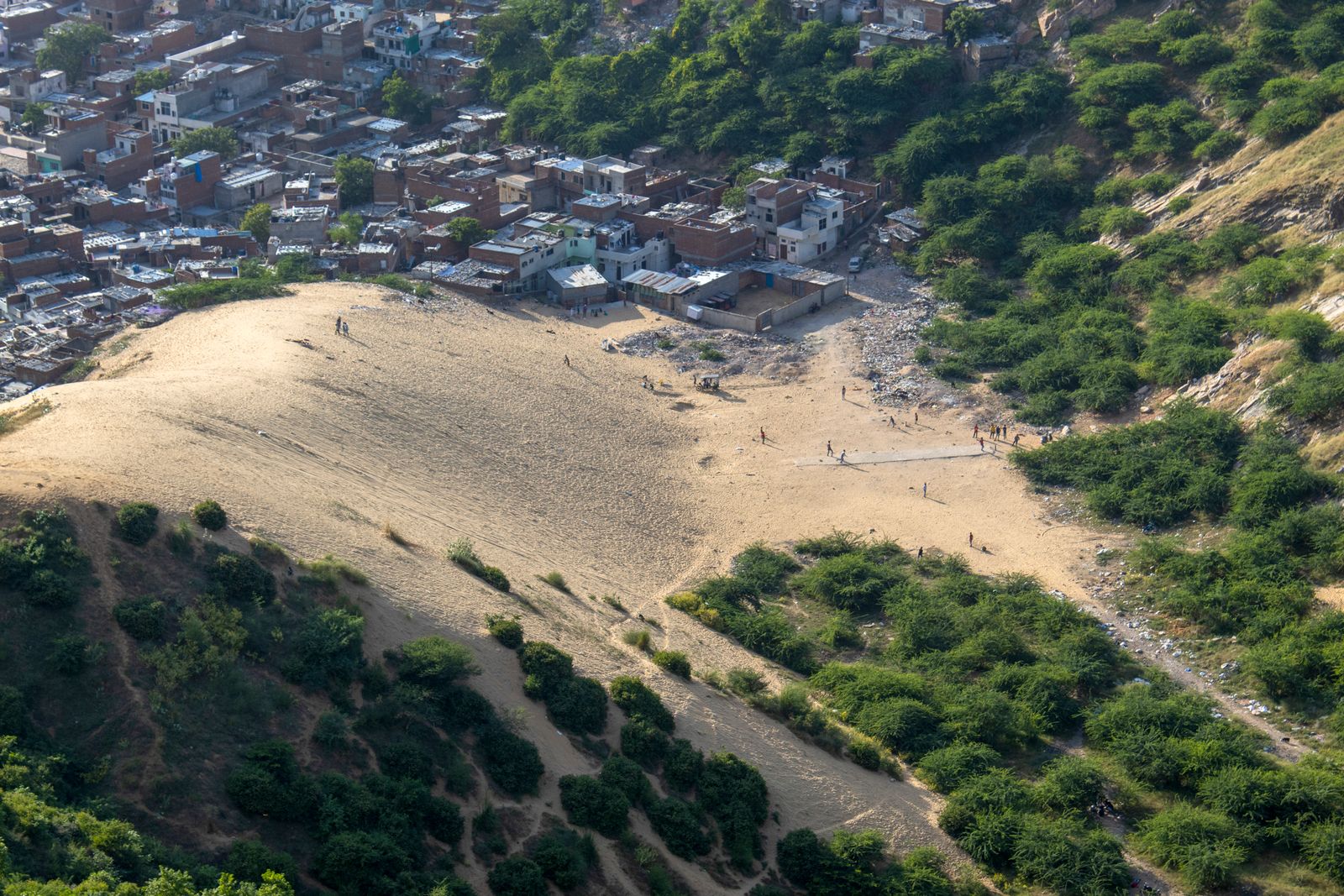 Sandy slope and town edge typical of western Rajasthan